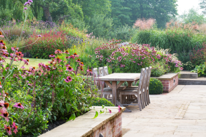 Manor garden with brick wall and pink flowers