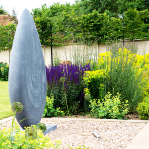 Swimming pool courtyard with large grey feature
