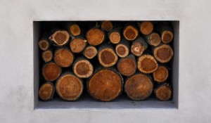 Swimming pool courtyard with large logs
